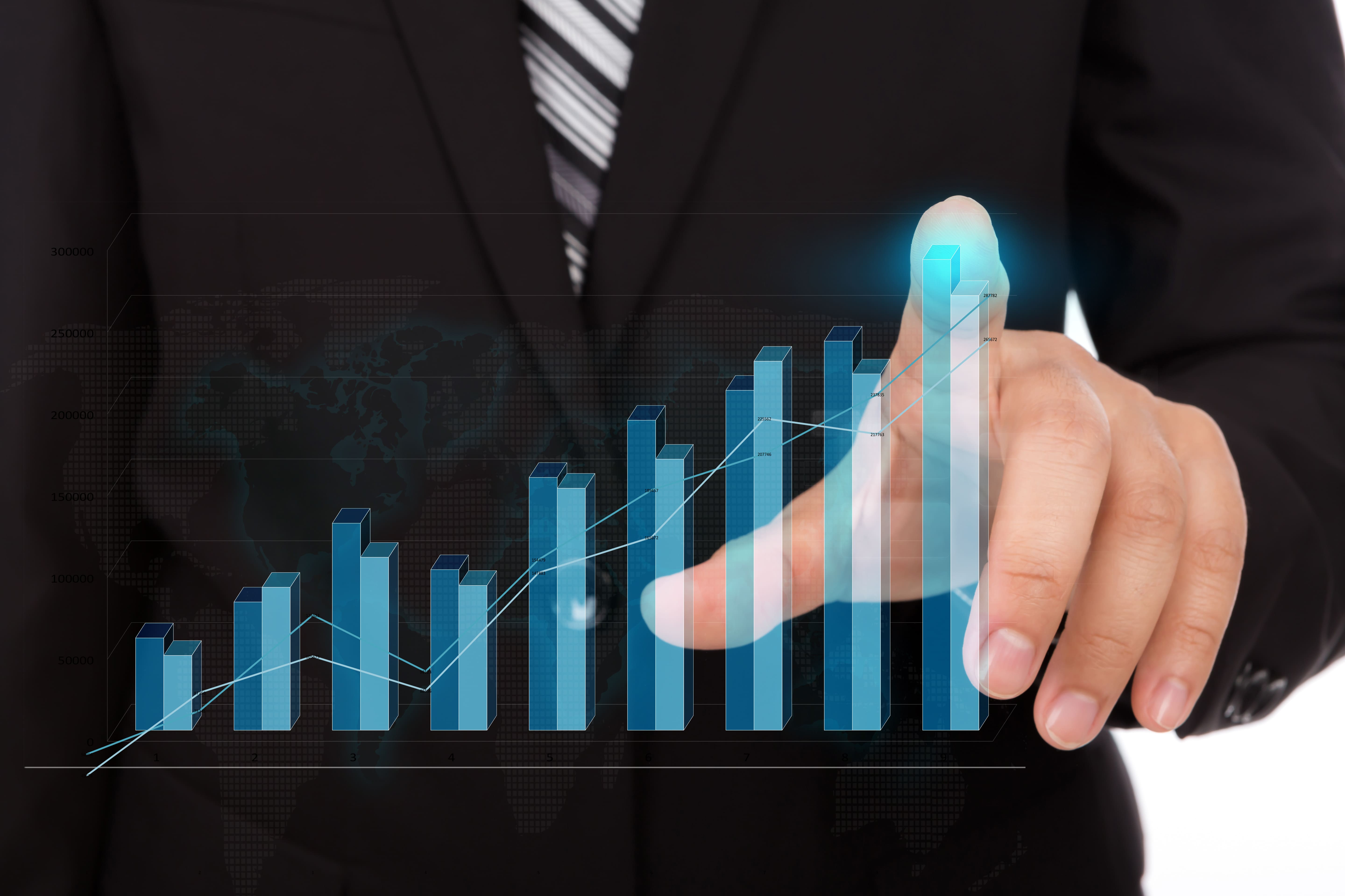 businessman touching the tip of a bar chart 1