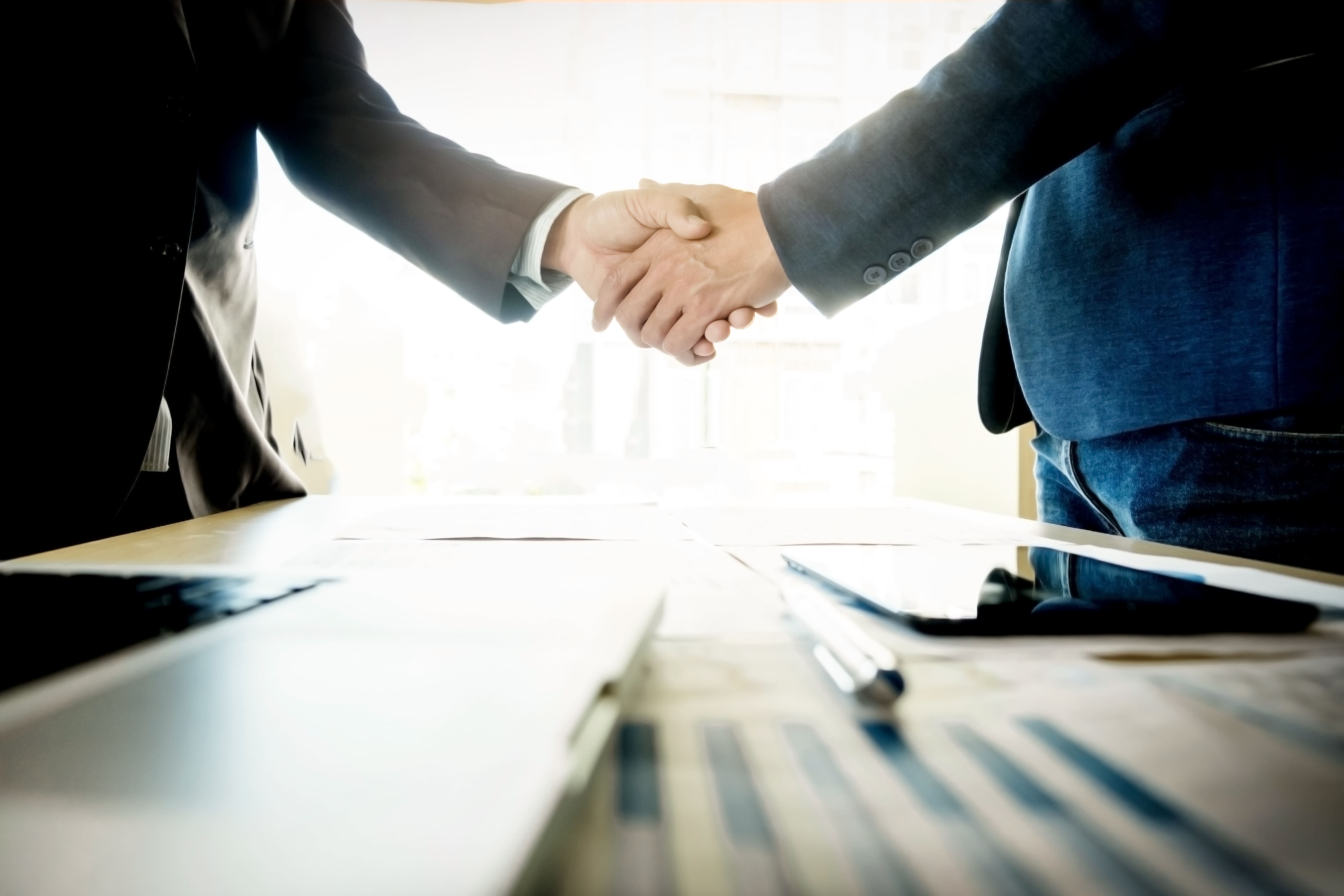 businessmen shaking hands during meeting 1